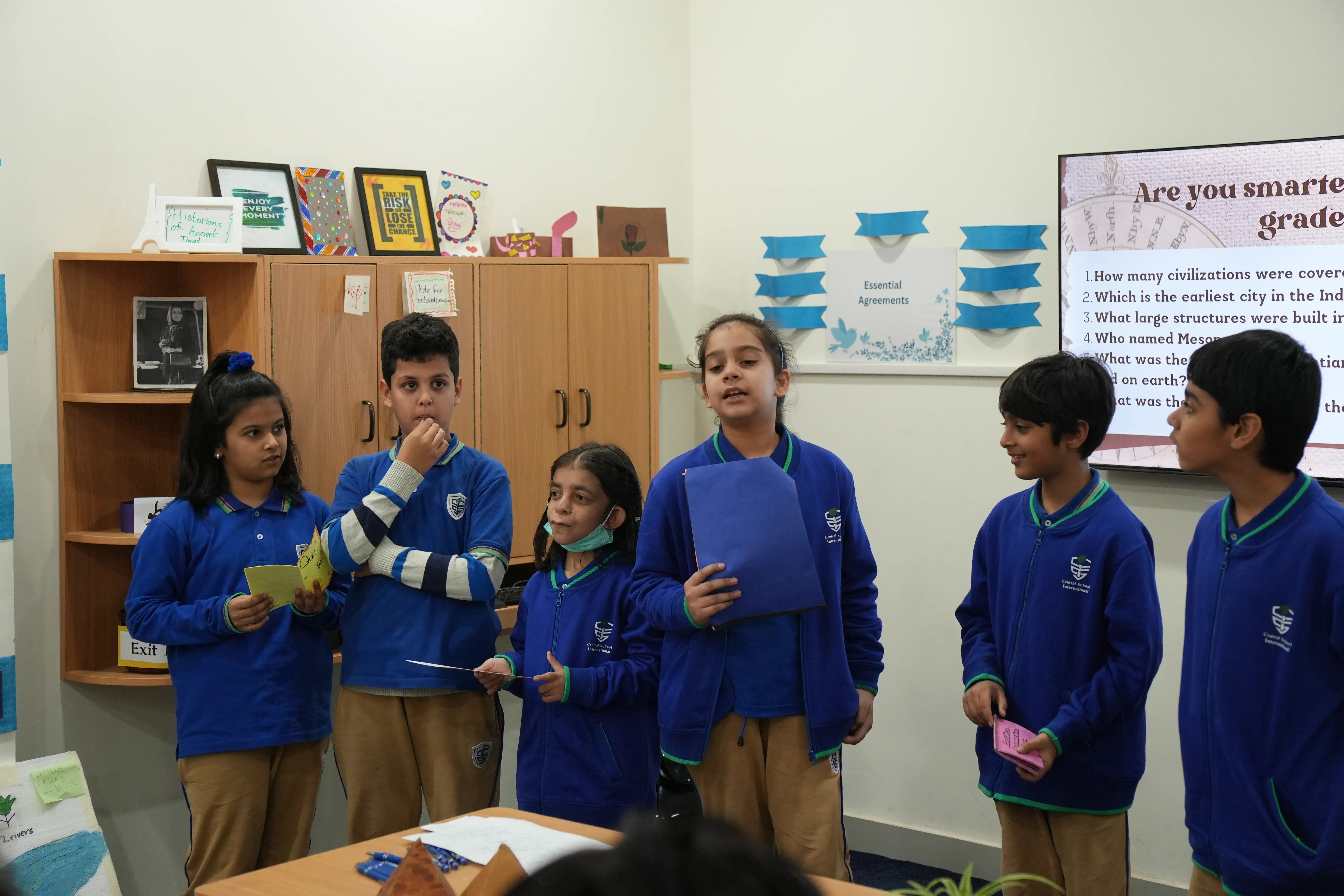 A CSI teacher guiding middle years students through classroom work
